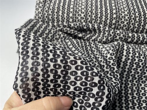 Fastvævet polyester - fine små cirkler på hvid bund